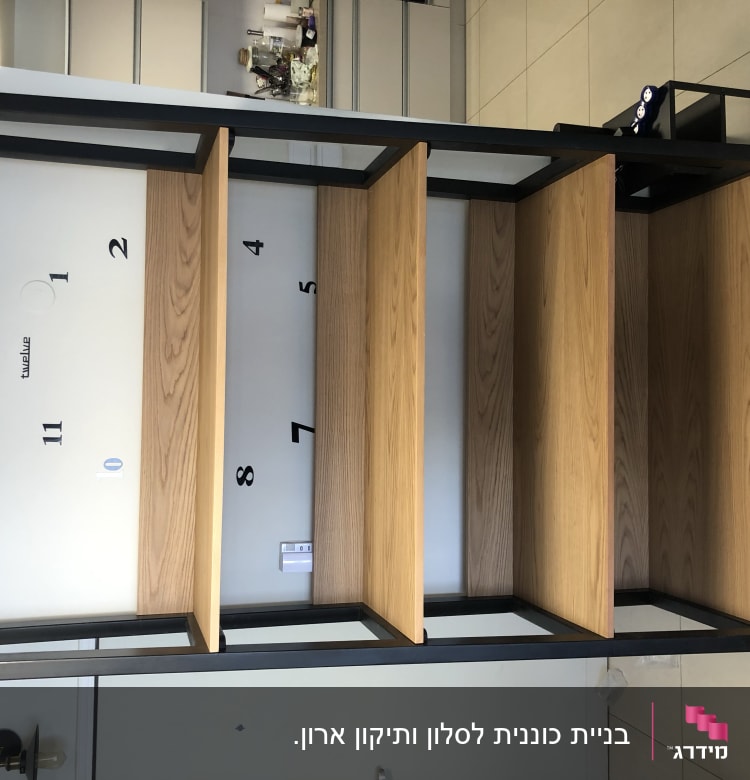 מדפי עץ עם מסגרת מתכת על קיר לבן